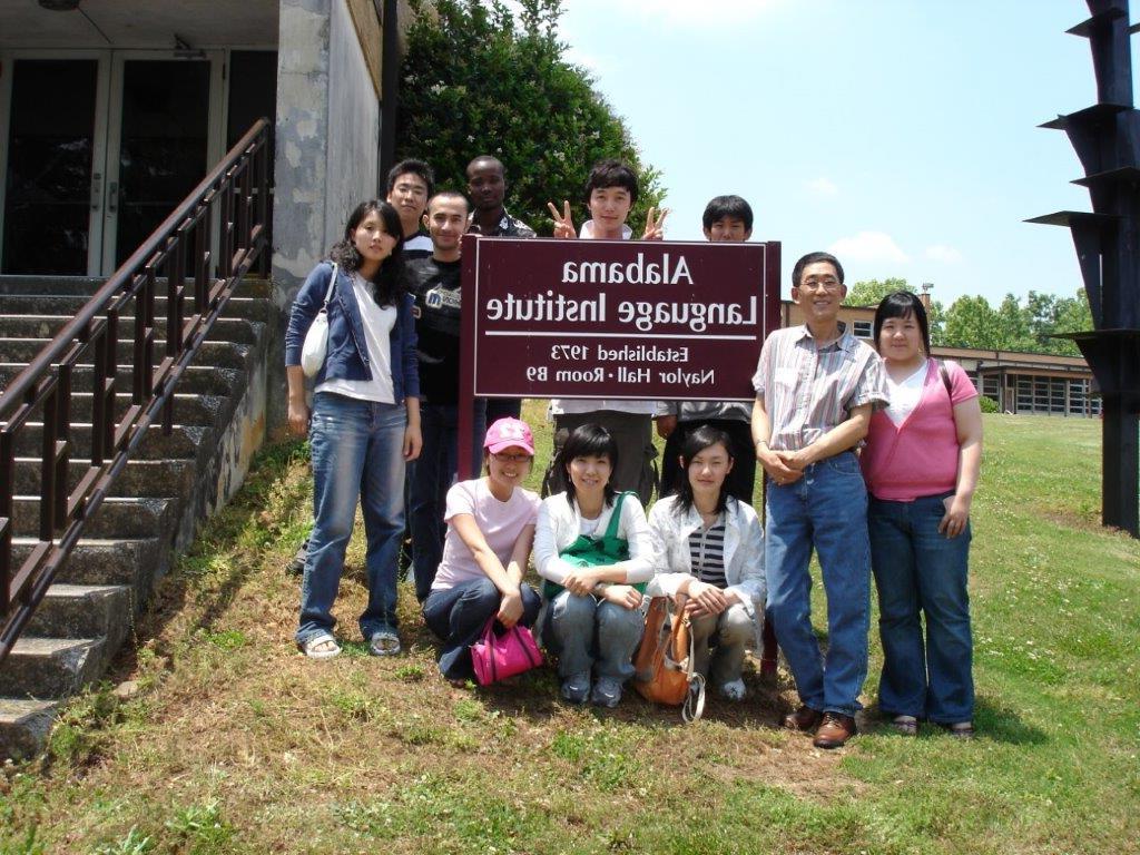 Students with the Alabama Language Institute signage